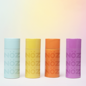 Lineup of Nöz Nose sunscreen stick in blue, yellow, orange and purple.