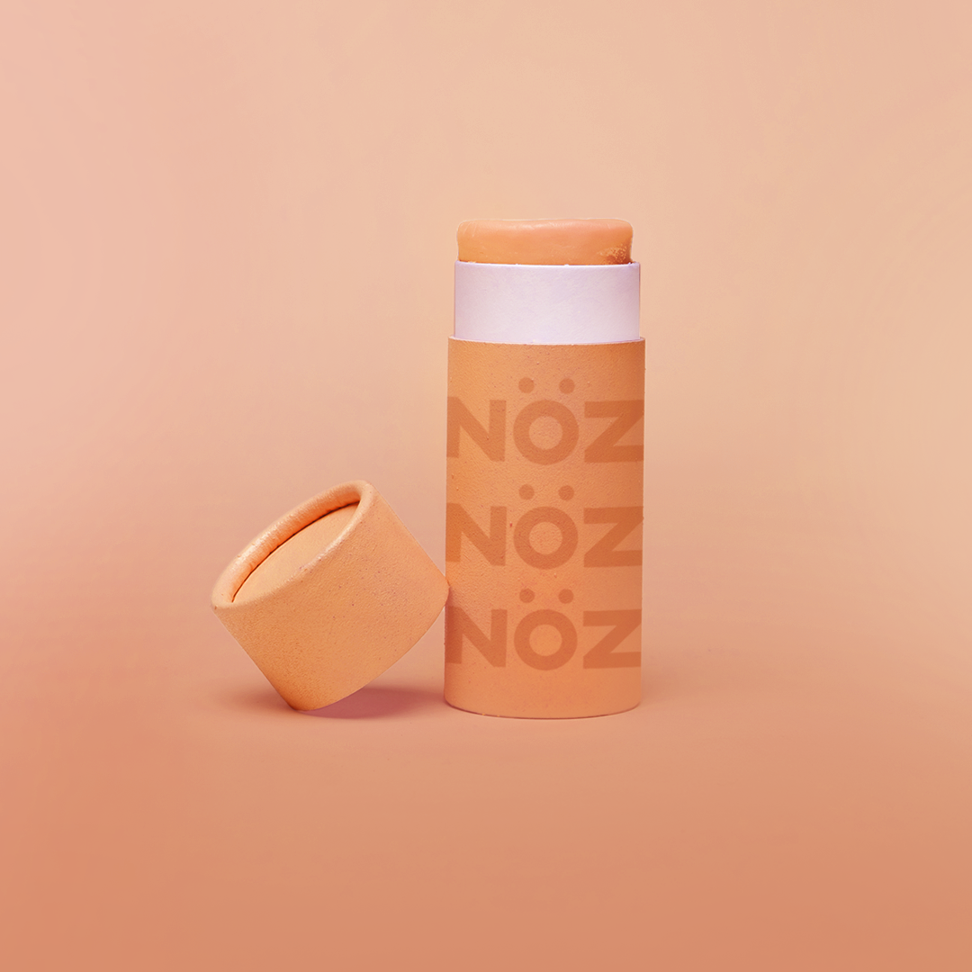 Orange color of Nöz nose sunscreen stick uncapped