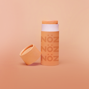 Orange color of Nöz nose sunscreen stick uncapped